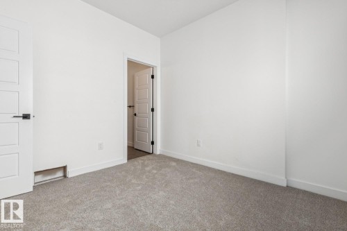 Plush carpeting and crisp white walls throughout - 11336 130 Street Nw, Edmonton, AB 