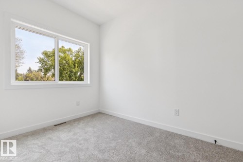 White walls with a single window and gray carpet - 11336 130 Street Nw, Edmonton, AB 