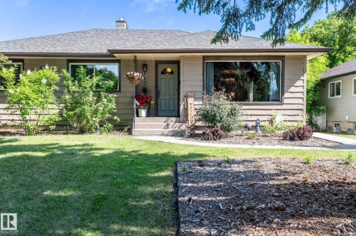 Single-story residence featuring horizontal siding and a dark gray shingle roof - 14708 108 Av, Edmonton, AB 