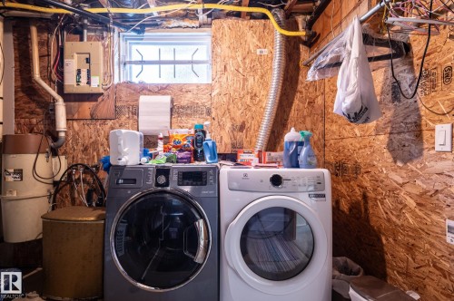 Dedicated laundry area with a front-loading washing machine and dryer - 14708 108 Av, Edmonton, AB 