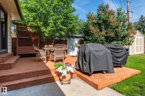 Expansive wood deck with multi-level design and slatted privacy screen - 14708 108 Av, Edmonton, AB 