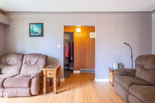 Neutral wall finishes complemented by wood-finish flooring - 14708 108 Av, Edmonton, AB 