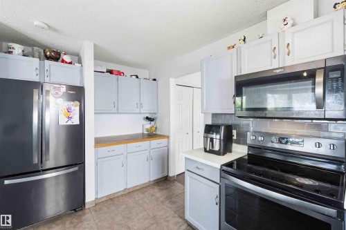 Stainless steel appliance suite featuring a black range and microwave - 18808 72A Avenue, Edmonton, AB 