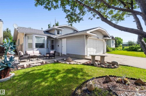 Single-family residence with light-colored siding, an attached garage, and a concrete driveway - 18808 72A Avenue, Edmonton, AB 