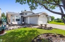 Single-family residence with light-colored siding, an attached garage, and a concrete driveway - 18808 72A Avenue, Edmonton, AB 
