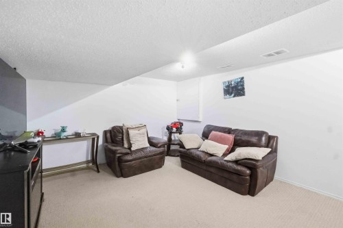 Carpeted room with white walls and a textured ceiling - 18808 72A Avenue, Edmonton, AB 