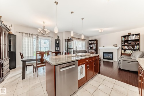 Kitchen island with granite countertop and double stainless steel sink - 8730 180A Avenue, Edmonton, AB 