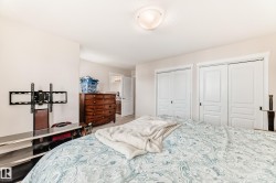 Bedroom featuring two sliding panel closet doors with white trim - 
