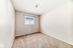 Neutral-toned walls complement the textured carpet flooring - 
