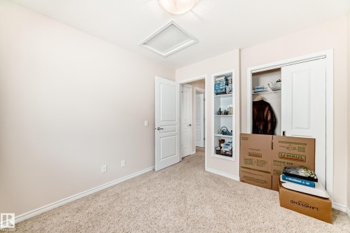 Neutral-toned room featuring light beige walls and carpeting - 8730 180A Avenue, Edmonton, AB 