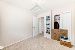 Neutral-toned room featuring light beige walls and carpeting - 