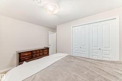 Room featuring neutral wall tones, white trim, and bi-fold closet doors - 