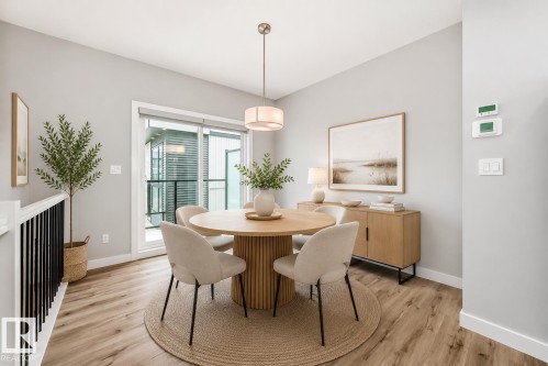 Dining area featuring wood-finish flooring, a contemporary chandelier, and light gray wall tones - 26 1729 Keene Crescent, Edmonton, AB 