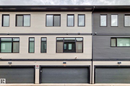 Modern townhome facade featuring light and dark horizontal siding - 26 1729 Keene Crescent, Edmonton, AB 