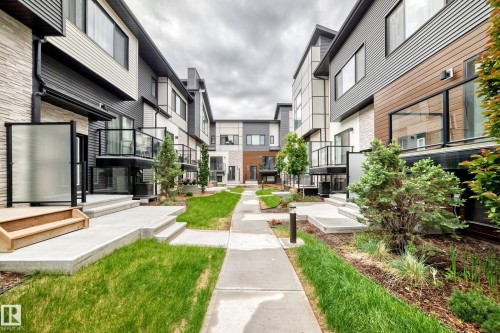 Modern townhome architecture featuring varied facade materials, including horizontal siding and brick-finish accents - 26 1729 Keene Crescent, Edmonton, AB 