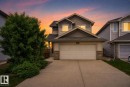 Two-story residence featuring light-colored siding, a prominent two-car garage, and a concrete driveway - 4612 Westcliff Point(E), Edmonton, AB 