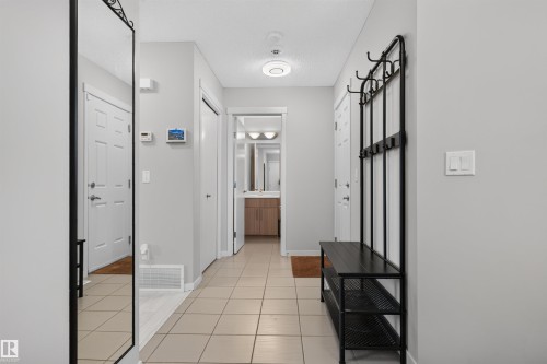 Bright entryway featuring light neutral wall paint and square tile flooring - 4612 Westcliff Point(E), Edmonton, AB 