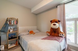 Spacious room with light neutral wall paint and a large window featuring white framing and curtain rod - 