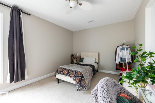 Bedroom with light neutral wall paint, white trim, and a ceiling fan - 8 2703 79 Street, Edmonton, AB 