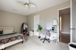 Spacious room with neutral wall tones and light-colored carpeting - 