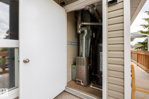 Utility closet housing essential systems, including a Bryant furnace and water heater - 8 2703 79 Street, Edmonton, AB 