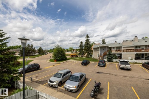 Outdoor parking area featuring multiple marked spaces - 8 2703 79 Street, Edmonton, AB 
