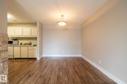 Open concept space featuring wood-finish flooring and a contemporary semi-flush mount ceiling fixture - 