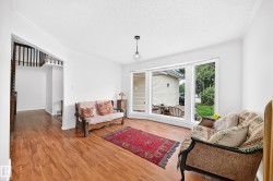 Bright living area with wood-finish flooring - 