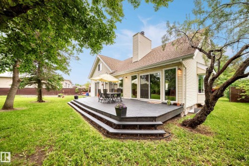 Rear exterior featuring a multi-level deck, white siding, and a brown shingle roof - 8224 186 Street Nw, Edmonton, AB 