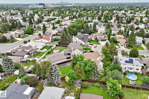 Expansive residential neighborhood featuring numerous mature trees and a distant cityscape - 8224 186 Street Nw, Edmonton, AB 