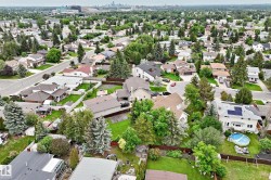 Expansive residential neighborhood featuring numerous mature trees and a distant cityscape - 