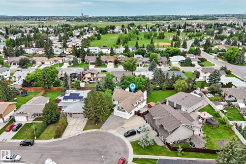 Residential property featuring a spacious backyard, mature trees, and a cul-de-sac location - 8224 186 Street Nw, Edmonton, AB 