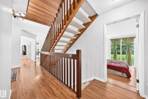 Upper-level hallway with wood-finish flooring and white walls - 8224 186 Street Nw, Edmonton, AB 