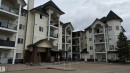 Multi-story condominium building featuring light-toned siding and dark pitched roofs - 202 13635 34 Street, Edmonton, AB 