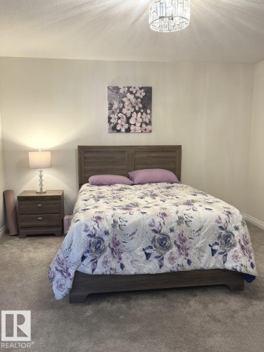 Plush carpeted flooring complements the light wall color - 305 11111 82 Avenue, Edmonton, AB 