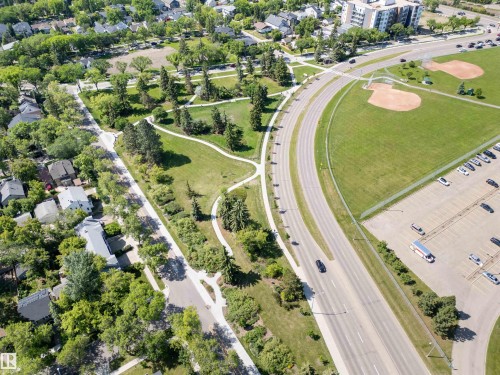 Aerial perspective showcasing a residential area bordered by a major roadway, green spaces, and community amenities - 305 11111 82 Avenue, Edmonton, AB 