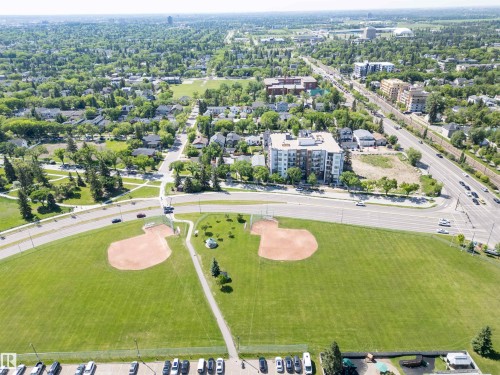 Aerial depiction of a residential neighborhood with extensive green spaces - 305 11111 82 Avenue, Edmonton, AB 