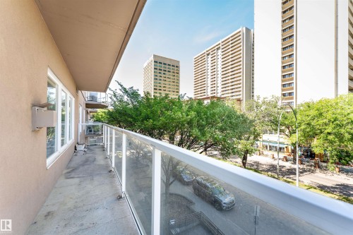 Private balcony featuring glass railings and concrete flooring - 305 11111 82 Avenue, Edmonton, AB 