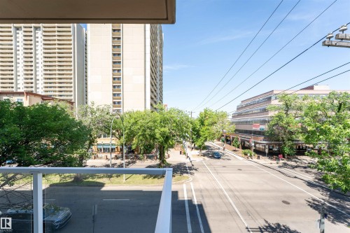 Balcony with glass railing overlooking urban streetscape - 305 11111 82 Avenue, Edmonton, AB 