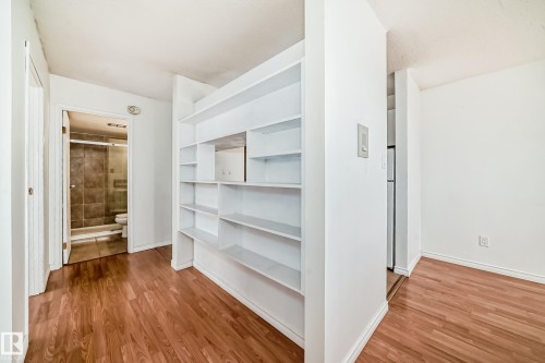 Built-in white shelving unit featuring multiple storage compartments - 401 11007 83 Avenue, Edmonton, AB 