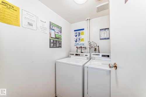 Dedicated laundry area featuring two white top-loading washing machines - 401 11007 83 Avenue, Edmonton, AB 