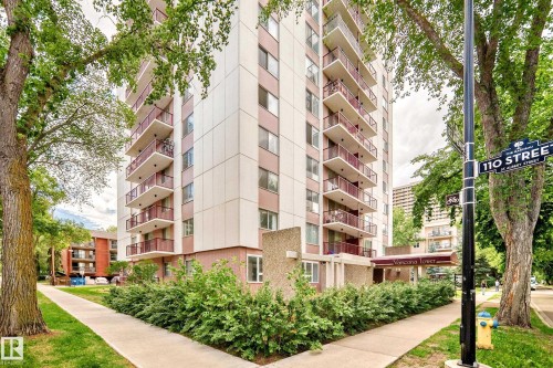 High-rise building featuring multiple balconies with metal railings, a covered entrance, and ground-level landscaping - 401 11007 83 Avenue, Edmonton, AB 