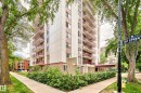 High-rise building featuring multiple balconies with metal railings, a covered entrance, and ground-level landscaping - 401 11007 83 Avenue, Edmonton, AB 