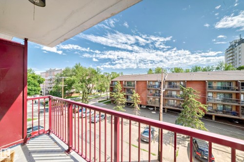 Balcony with red metal railings and a concrete floor - 401 11007 83 Avenue, Edmonton, AB 