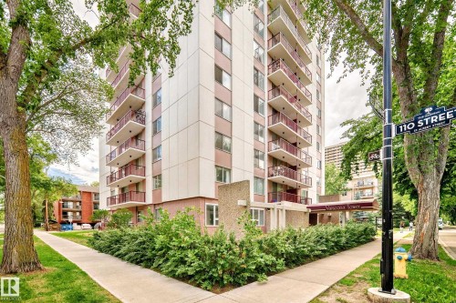 Multi-story residential building featuring balconies with red railings and a ground-floor awning - 401 11007 83 Avenue, Edmonton, AB 