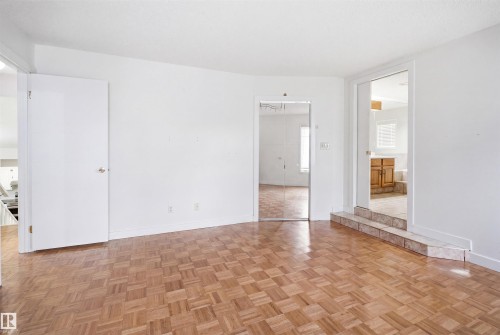 Parquet wood-finish flooring provides a warm foundation for this versatile space - 3220 42A Avenue, Edmonton, AB 