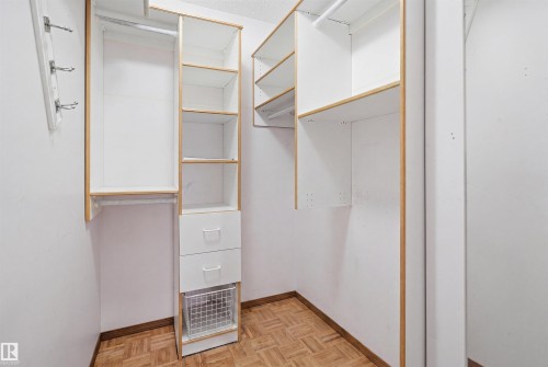 Custom closet system featuring white shelving with natural wood trim - 3220 42A Avenue, Edmonton, AB 