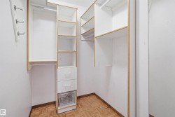 Custom closet system featuring white shelving with natural wood trim - 
