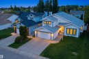 Two-story residence featuring white siding with blue trim accents and a multi-pitched roof - 3220 42A Avenue, Edmonton, AB 