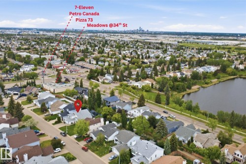Residential neighborhood featuring single-family homes, mature trees, and a nearby body of water - 3220 42A Avenue, Edmonton, AB 